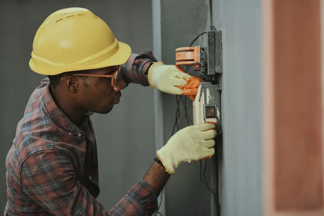 Electrical technician working on a distribution panel